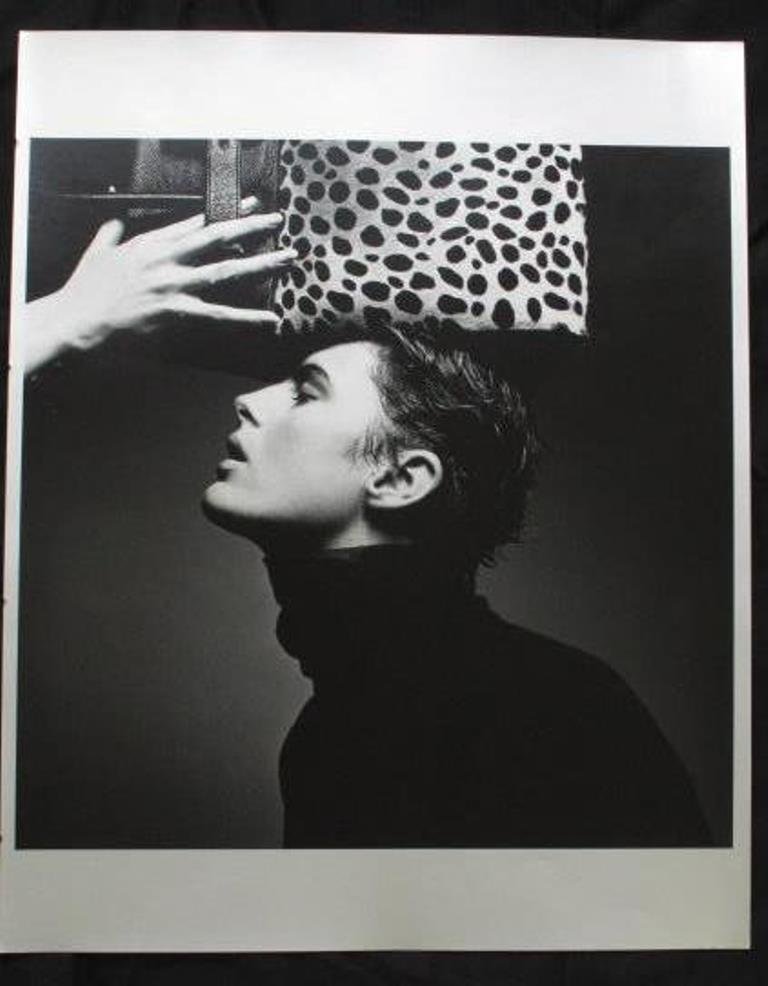 Michel Comte (1954-) Silver Gelatin Print: Metallic silver gelatin print by acclaimed Swiss fashion photographer Michel Comte. Depicting a female model with an animal-print handbag held over her head. 20 inches height and 16 inches width. 20"H