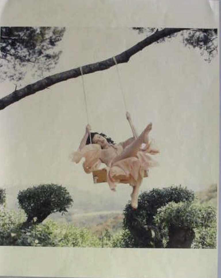 Michel Comte (1954-) Photo Print of Debi Mazar: Chromogenic print of photograph by Michel Comte. Depicting actress Debi Mazar on swing. Sticker to back dates the picture to 1994 and has address and phone number of artist at the time. 20 inches heig
