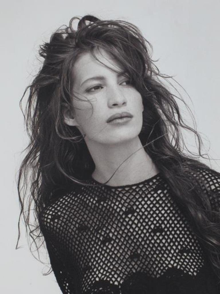 Michel Comte (1954-) Fashion Print: Photographic fashion print in black and white on baryta paper by Michel Comte. Depicting a female model in a fishnet shirt and black tulle skirt. Artist's mark in pencil and stamp to verso. 20 inches