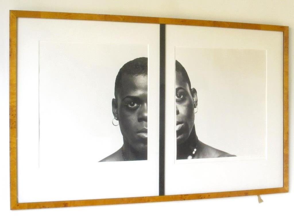 Michel Comte (1954-) Split Photograph: Pair of black and white prints by Michel Comte in a single wood veneered frame. Depicting a young woman's face which is split between the two prints and a black bar. Housed with a single matte. 34 inc