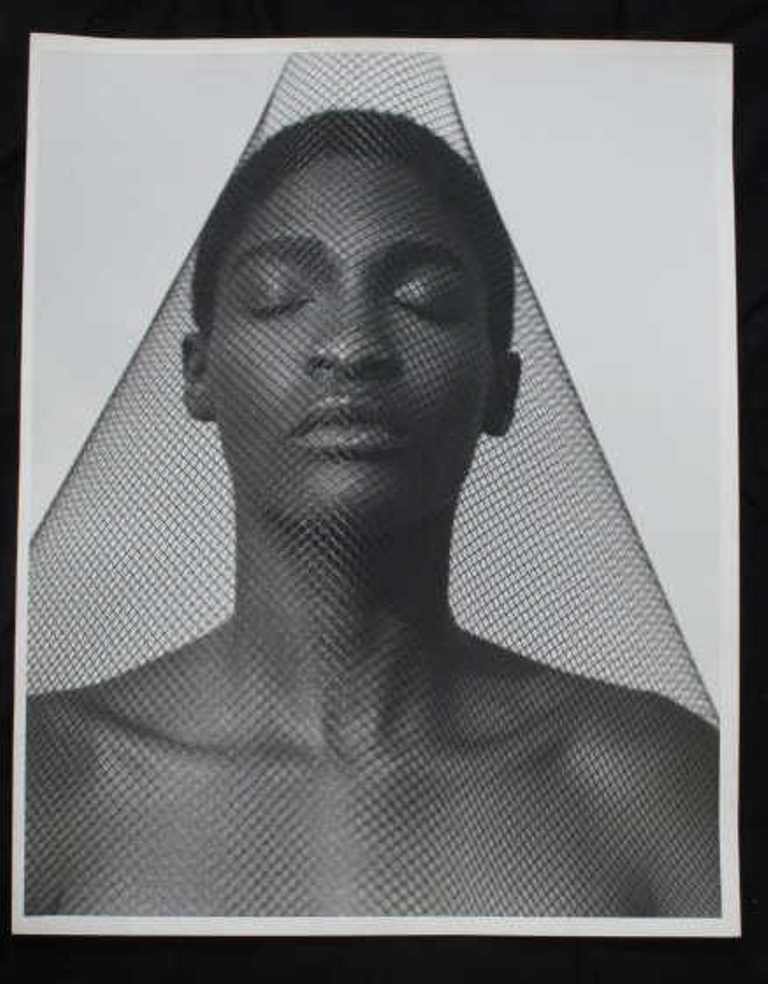 Michel Comte (1954-) Black and White Print: Black and white photographic print of baryta paper by Michel Comte. Depicting a woman with closed eyes under a canopy of black netting. 20 inches height and 16 inches width. 20"H x 16"W x 0.25"D Good