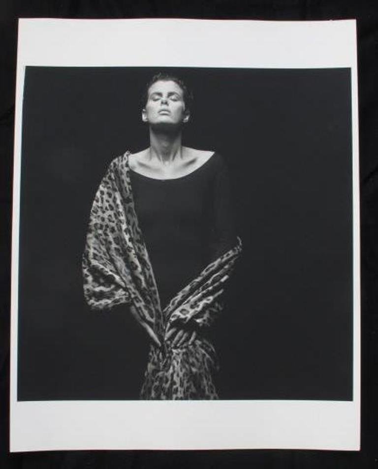 Michel Comte (1954-) Fashion Print: Black and white photographic print on baryta paper by fashion photographer Michel Comte. Depicting a female model in a black dress with a leopard-print garment wrapped around her. 20 inches height and