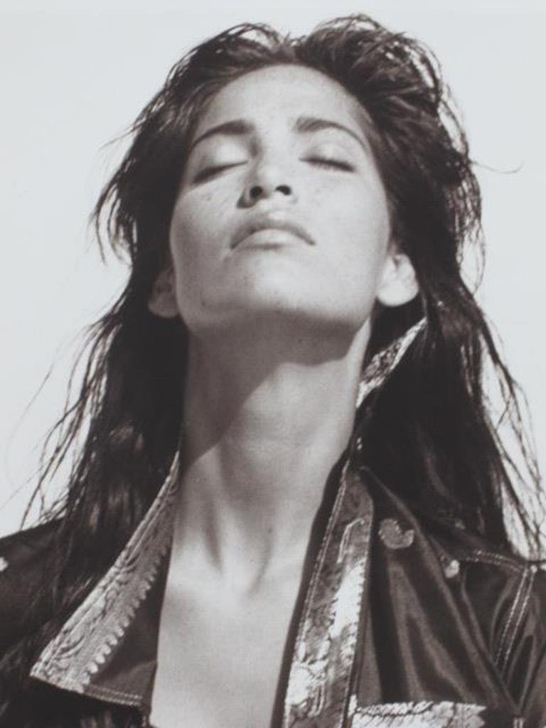 Fashion Print by Michel Comte: Black and white photographic print on baryta paper by Michel Comte. Depicting a female model wearing 1990s-style jacket and jeans with eyes closed and face tilted upward. Artist's marks in pencil and