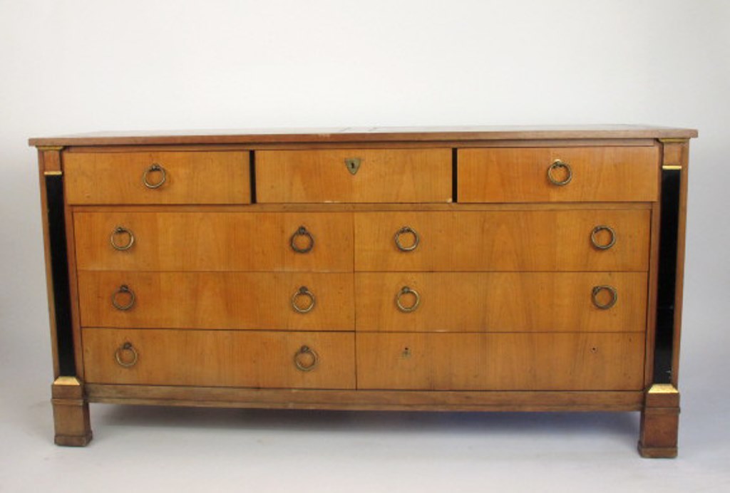 Empire Style Satin Mahogany Dresser: 20th century. Fitted with nine drawers all with ring pulls. In a light mahogany finish. 32"H x 64"L x 19"D Scratches and marks to finish Dimension: 32"H x 64"L x 19"D Provenance: