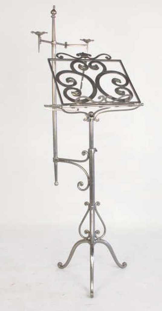 Stainless Steel Candle Lit Music Stand: 20th century. The scrolled polished iron adjustable lectern with two attached candle arms. 64 inches height. 64"H Good overall Rhode Island, NY Mansion. Dimension: 64"H Provenance: Rhode Island, NY Ma