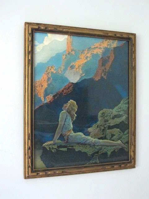 Maxfield Parrish (1870-1966) "Wild Geese" Print: Lithograph by Maxfield Parrish depicting a young woman lying on a rocky outcropping looking upward towards the sun and large mountains. Housed in a carved wood frame. 14.5 inches height, 11.25 inches