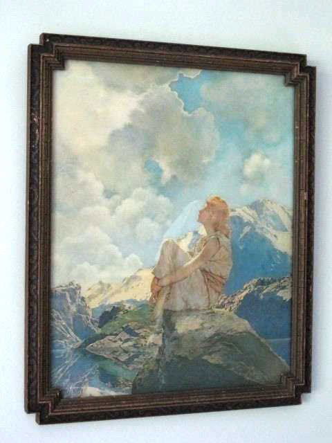 Maxfield Parrish (1870-1966) "Morning" Print: Lithograph of "Morning" by Maxfield Parrish. Depicting a young woman in classical robes seated on a crag in a mountainous landscape. Housed in a painted wood frame. 14.5 inches height, 11.75 inches de