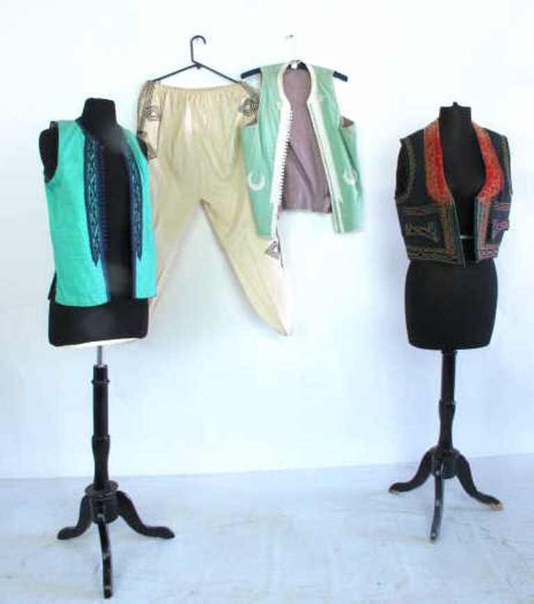 Group Lot of Three Vests and Pants Grouping of three: Grouping of three small, embroidered and embellished South Asian style vests. Also including a pair of embroidered white pants. 21 inches length, 18 inches width. 21"H x 18"W Measurements: 21"H x 18"W