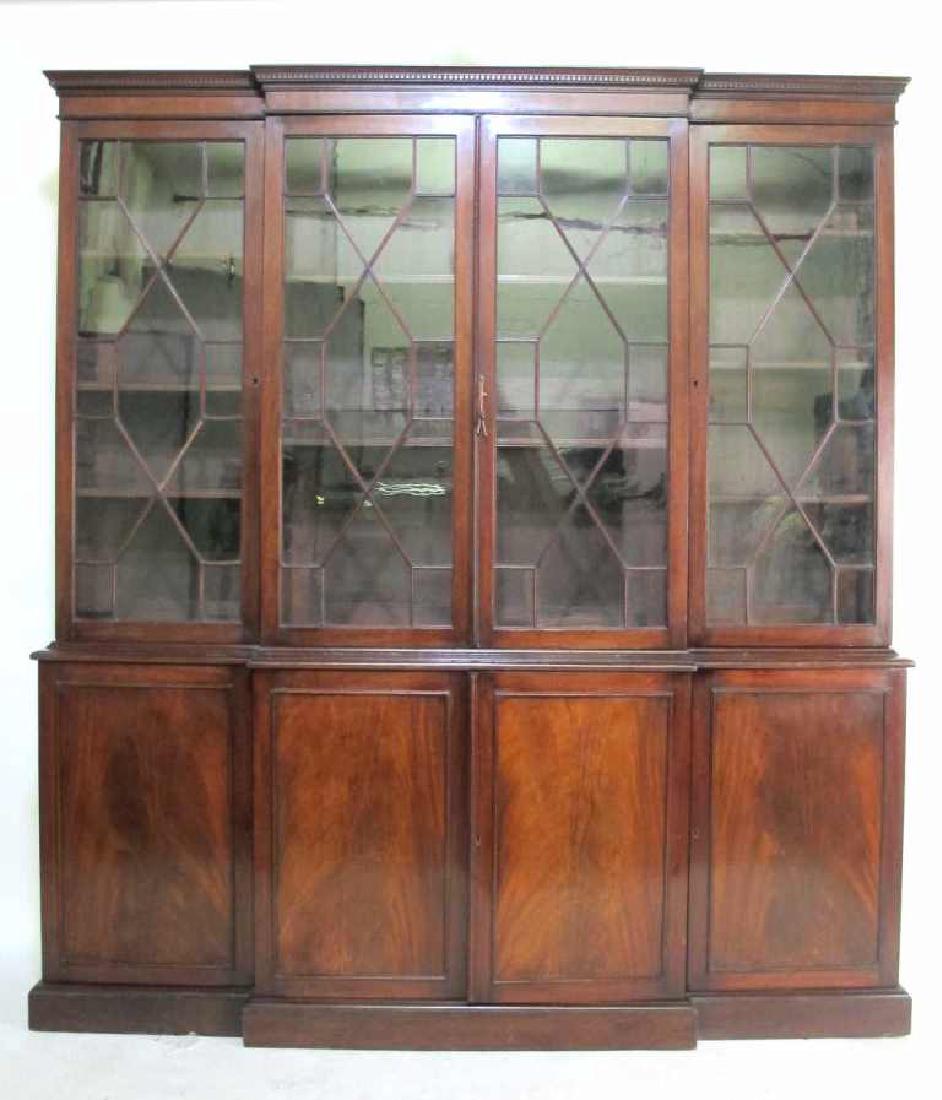 Mahogany Breakfront w/ Dental Crest Molding 20th: 20th century. Having four doors, each set with glass panels in a wood lattice work on a base with four doors. Each with beaded moldings and inset flame mahogany panels. Some scratches and marks to fin