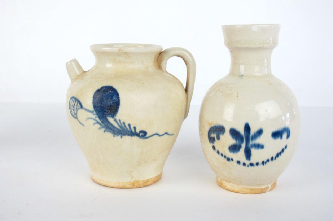Chinese Blue and White Vase and Pitcher: Blue and white ceramic Chinese vase having rounded body with floral motif and mark to bottom. Also including rounded pitcher with handle and blue and white foliate motif with same mark to bottom. 6.5 