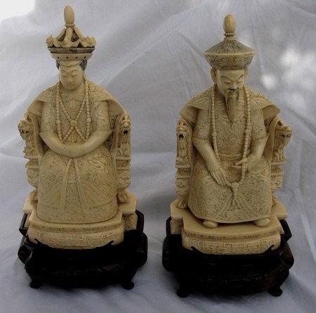 Pair Chinese Antique Ivory Ancestrals 19th C.: Beautifully and intricately carved and signed pair of noble ancestral solid ivory hand carved figures on custom carved rosewood stands. Details include regal necklaces, dragon chairs, and bird headdre