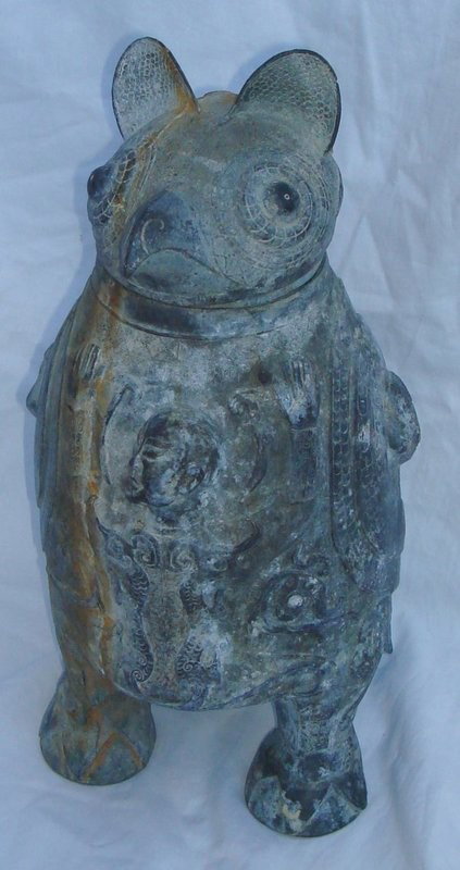 Archaic Chinese Zhou Taotie Zun Bronze Vessel and: Striking archaic late Shang/early Zhou style Zun bronze ceremonial Owl vessel and cover (hu) features classic three legged structure, highly skilled artistic extensive chasing including taotie dragon 
