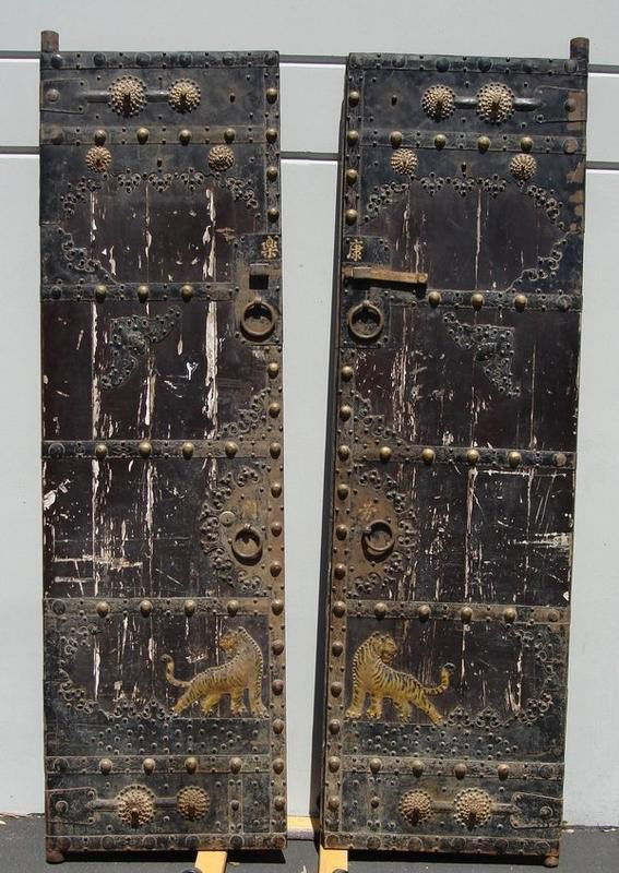 Antique Chinese Doors Gates 18th C Teak Iron 8': Massive 8 foot rare heavy solid teak wood antique Chinese royal doors with decorative iron riveted hammered metal including tiger figures. Large heavy iron hinges, fittings and hardware. Circa late 17