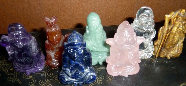 Antique Japanese Rock Crystal Group 7 Lucky Gods: Antique striking set of carved rock crystal group of the Japanese Seven Lucky Gods made of striking colorful crystals such as amethyst, amber, lapis, amazonite, rose quartz, clear quartz, and tiger ey