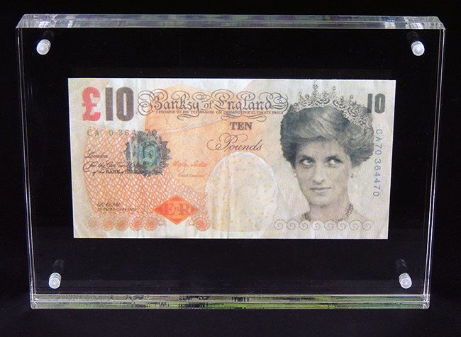 Banksy, 10 Pound banknote: Banksy, 10 Pound note Provenance: Private Collection, London measurement: 5.7 x 3.4 inch Plexiglas: 7.1 x 5.2 x 1 inch Banksy, Di-faced tenner, 2004. A 10 Pound note, realistic, colourful note with a