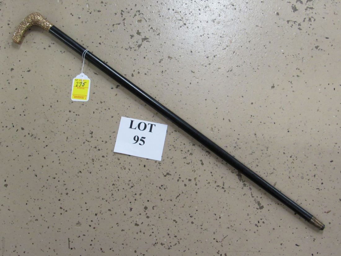 PRESENTATION CANE: WALKING CANE PRESENTED TO PRESIDENT FAJAN FROM THE MEMBERS OF THE WEBER BUND, CIRCA LATE 19TH CENTURY. A BLACK CANE WITH A HIGHLY CHAISED GOLD FILLED HANDLE ENGRAVED TO FAJAN. 34" LONG