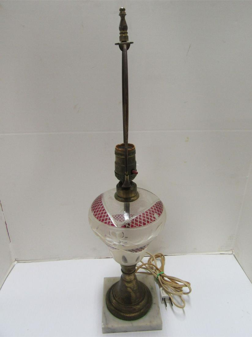 PARKESBURG LAMP: CUT TO CLEAR PARKESBURG LAMP. WHITE AND RED GLASS. WHITE MARBLE BASE. ELECTRIFIED WITH HARP ABOVE. 14" TALL X 5 1/2" ROUND