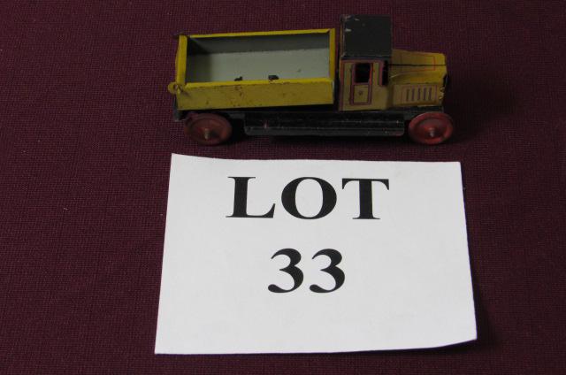 Yellow and Red German Tin Litho Dump Truck: Yellow and Red German Tin Litho Dump Truck, Marked CF on both Sides, Measures 4-1/4" l x 1-1/4" w x 2" h, Paint Loss and Oxidation