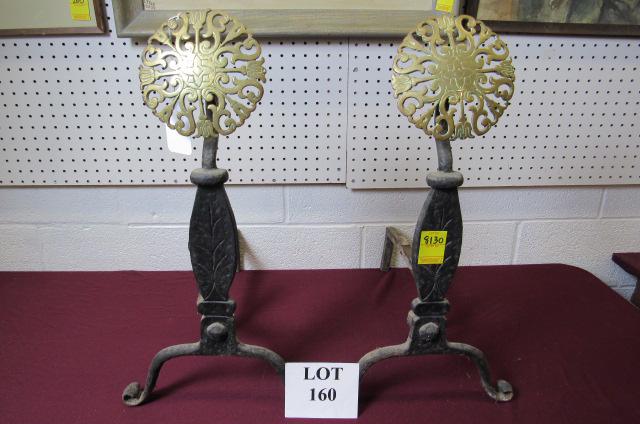 Pair of Mid Century Cast Iron Andirons: Pair of Reproduction Mid Century Cast Iron Andirons with Ornate Round Brass Medallion and Curled Feet, Measures 20" l x 12-1/2" w x 24" h