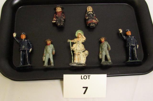 (7) Metal Figures Including: Amish Man and Woman: (7) Metal Figures Including: Amish Man and Woman, Police Officers, Man Holding Pail and Woman in Fancy Dress, Largest 3-1/2" h