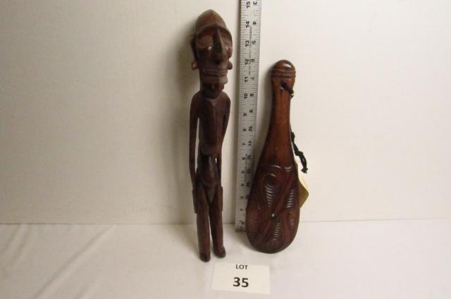 Wood Carvings: Carved male figure from Easter Island, 15" T. New Zealand Maori Hand club by the finest carvers in the Pacific.12 1/2" L.