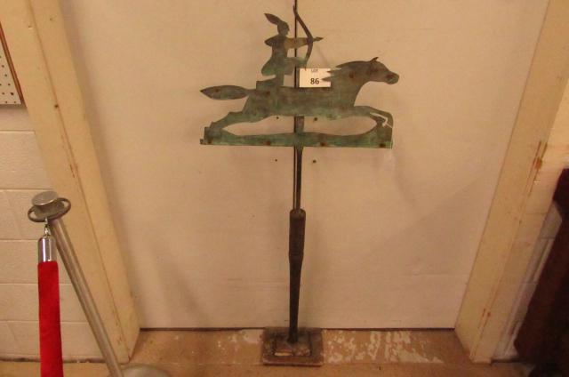 Indian Weathervane: Copper Indian weathervane, old riveted construction. Great patina. An Indian kneeling ready to shoot his bow and arrow on his horse while galloping at full speed. On a wood stand. 23" L x 25 1/2" T wi