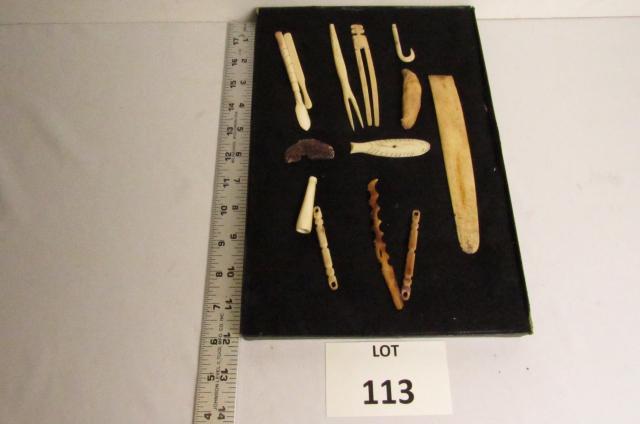 (13) Bone Artifacts: (13) Bone Artifacts in Riker Mount (Circa 19th Century) Including Bone Scraper, and Other Tools, Boar Tooth, (2) Hunting Fetishes, Pipe, Hair Ornament, and Fish Hook