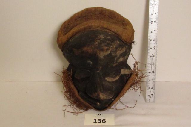 African mask: Wood carved African mask with turned face, beard and hat. 8" x 14".