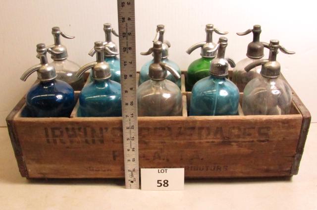 Seltzer Bottles: 10 seltzer bottles in assorted colors in wood crate. 23" x 9 1/2". Irwins Beverage, Phila, Pa.