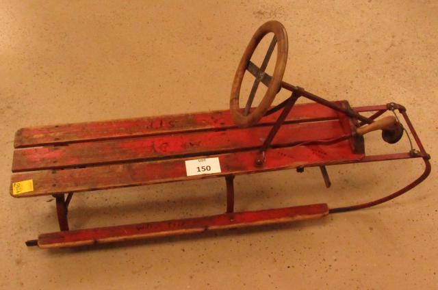 Unusual Snow sled: Turn of the century red painted wood and metal framed snow sled with wood steering wheel and wood handled spring tensioned hand brake. 45" long x 15" wide. One of a kind?! No maker noted. Pick up only