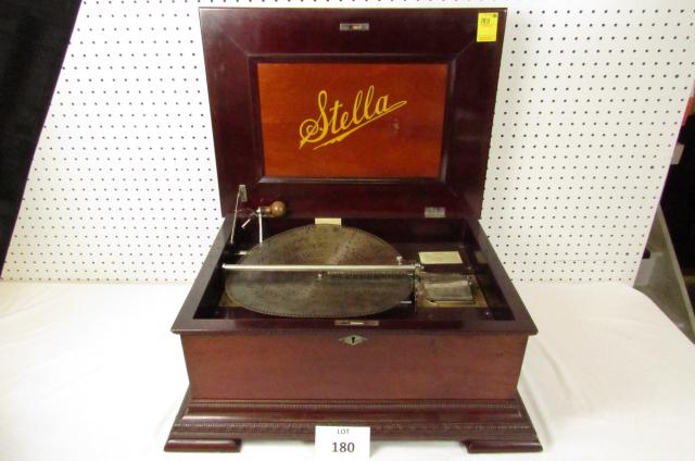 Stella disc music box: Stella 14" disc tabletop music box with one disc. Clean, working. Mahogany case with crank and cabinet key. Pick up only. We will not ship due to size and weight limitations.