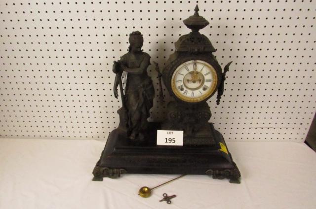 Ansonia figural clock: Ansonia Clock Co. figural mantle clock in spelter with Roman dial. Lovely Grecian maiden standing by a harp. *Note-chips in glass cover, chips in base's black paint. Clock is overwound. 19" long, 8 1/