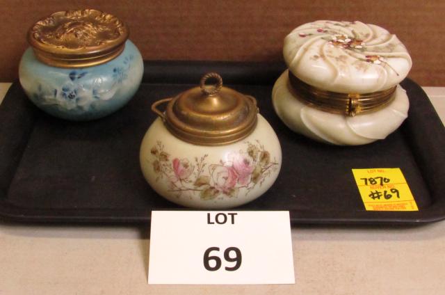 Three piece lot of vintage glass dresser jars with lids: Three piece lot of vintage glass dresser jars with lids ranging in size from 4" to 4.5" in diameter and in different colors/decorations