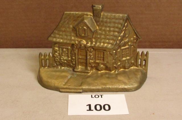 Cast iron doorstop of stone cabin: Cast iron doorstop of stone cabin. Measures approximately 7.5" x 5"