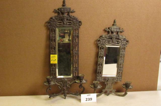 Lot with two different early metal walls sconces with: Lot with two different early metal walls sconces with beveled mirrors and dolphin decorations. One measures approximately 23" x 10" and the other measures approximately 18" x 11"