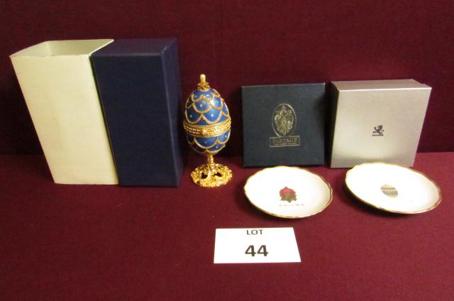 Egg - related lot: Boxed saucer marked Faberge' Limoges France with The Lilies of the Valley Egg. 4 1/4" diameter, boxed saucer marked Faberge' Limoges France with enameled gold Imperial Easter Egg, 4 1/4" diameter, Kin