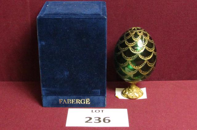 Faberge' egg: Faberge' signed, boxed green glass egg with etched gold colored decoration and gold colored decorative attached metal stand 4 1/2" tall x 2 1/2" wide