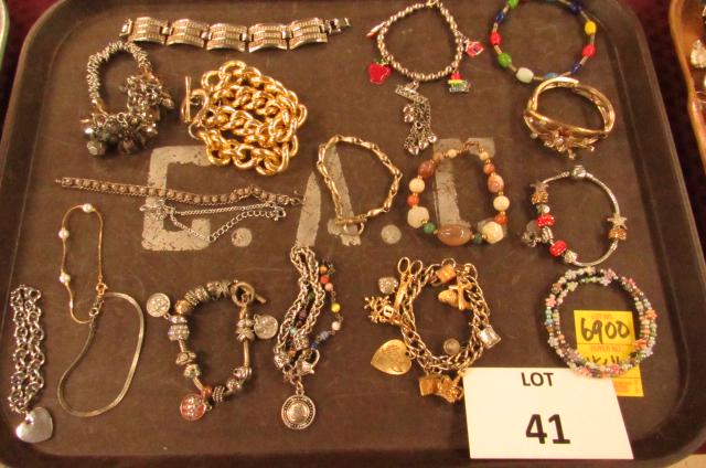 Costume jewelry lot: Gold and silver tone bracelets, charm bracelets, beaded bracelets