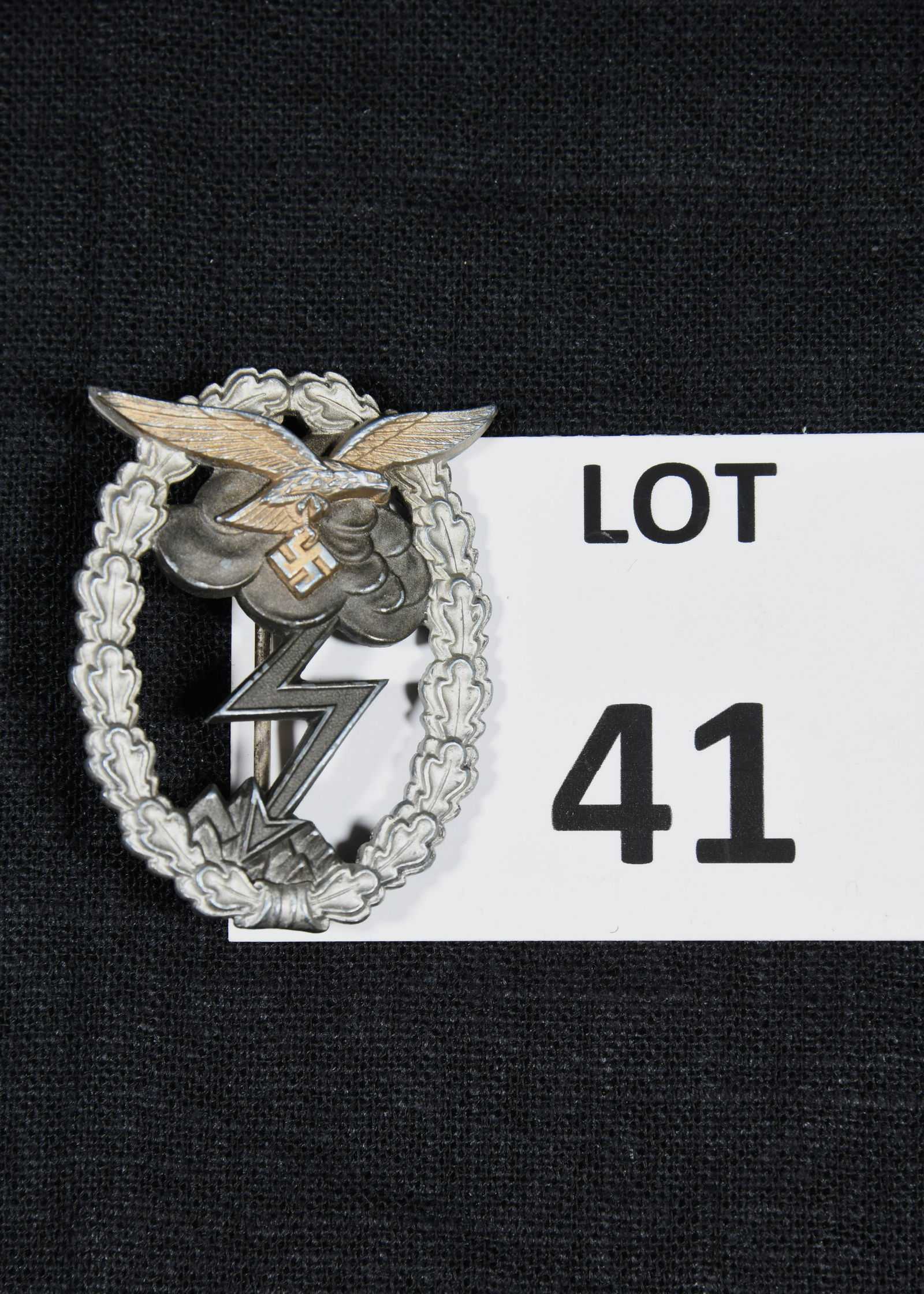 WWII German Ground Assault Badge of the Luftwaffe: A WWII German ground assault badge of the Luftwaffe. Pin depicts an eagle holding a swastika with wings spread. A storm cloud and lightning bolt is in the background and is surrounded by an oval shape