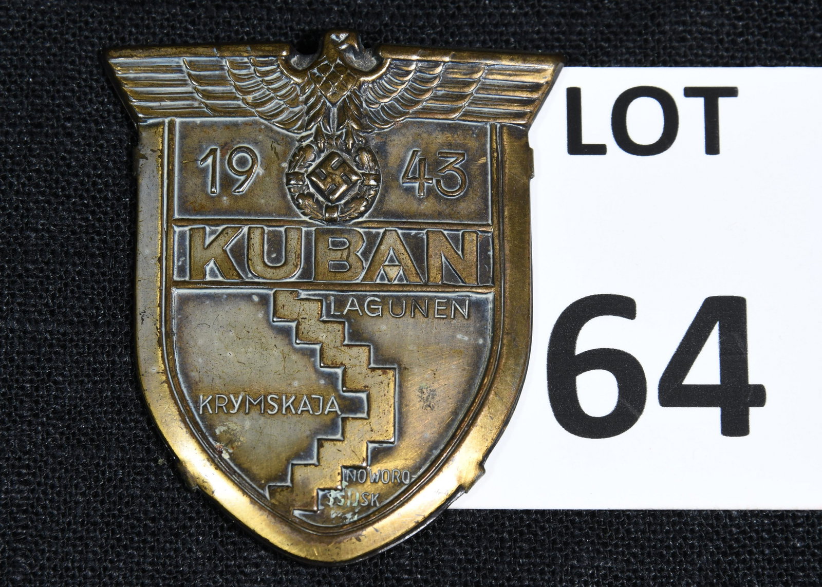 WWII German Kuban Shield Badge Award: A WWII German Kuban Shield badge which was awarded to Wehrmacht forces who fought at Kuban bridgehead in Soviet Union in 1943. This badge is made of zinc with a bronze wash. It has the German eagle cl