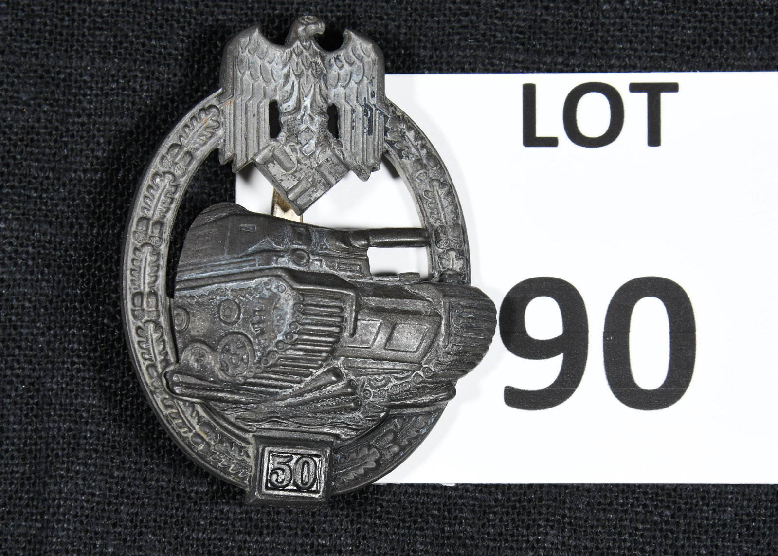 WWII German Panzer Assault Badge: A Panzer Assault badge which was awarded to troops in the armoured divisions of the Nazi Army during WWII. This badge features an oak leaf wreath with eagle and swastika at the top. A Panzer IV tank s
