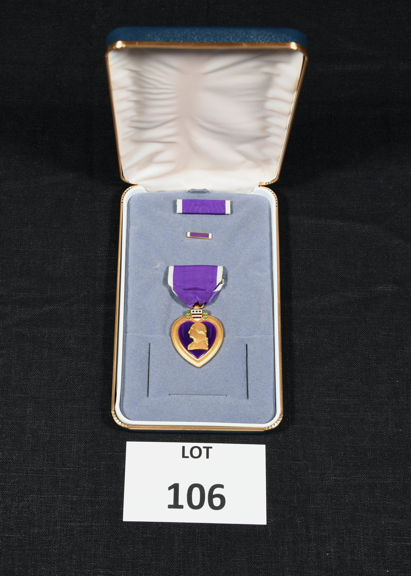 US Military Purple Heart Medal: A US Military Purple Heart medal. Profile of President George Washington against a purple background. Attached to a purple ribbon. The reverse side of the medal reads "For Military Merit." Includes ri