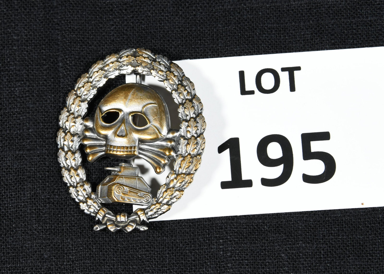 WWII Era German Condor Legion Badge: A WWII era German Condor Legion badge. This badge features an oval wreath of oak leaves containing a skull and crossbones above a German Panzer tank. *Disclaimer- We strive to list these lots with tho