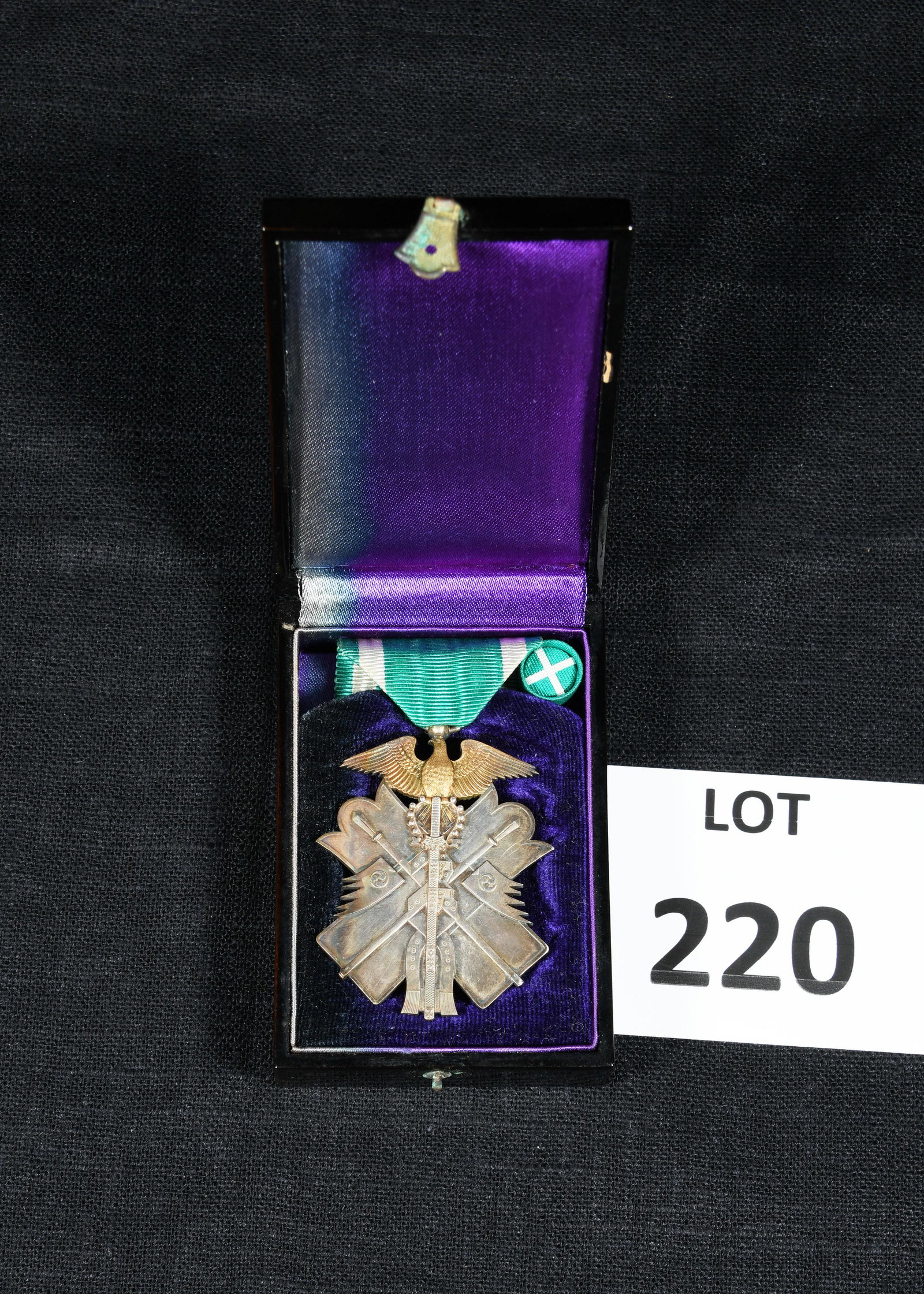 WWII Japanese Order of the Golden Kite 7th Class Medal: A WWII era Japanese Order of the Golden Kite medal, 7th class. Includes rosette. Medal attached to green and white ribbon. Presented in original laquered box with purple interior lining. Box is 3 1/2"