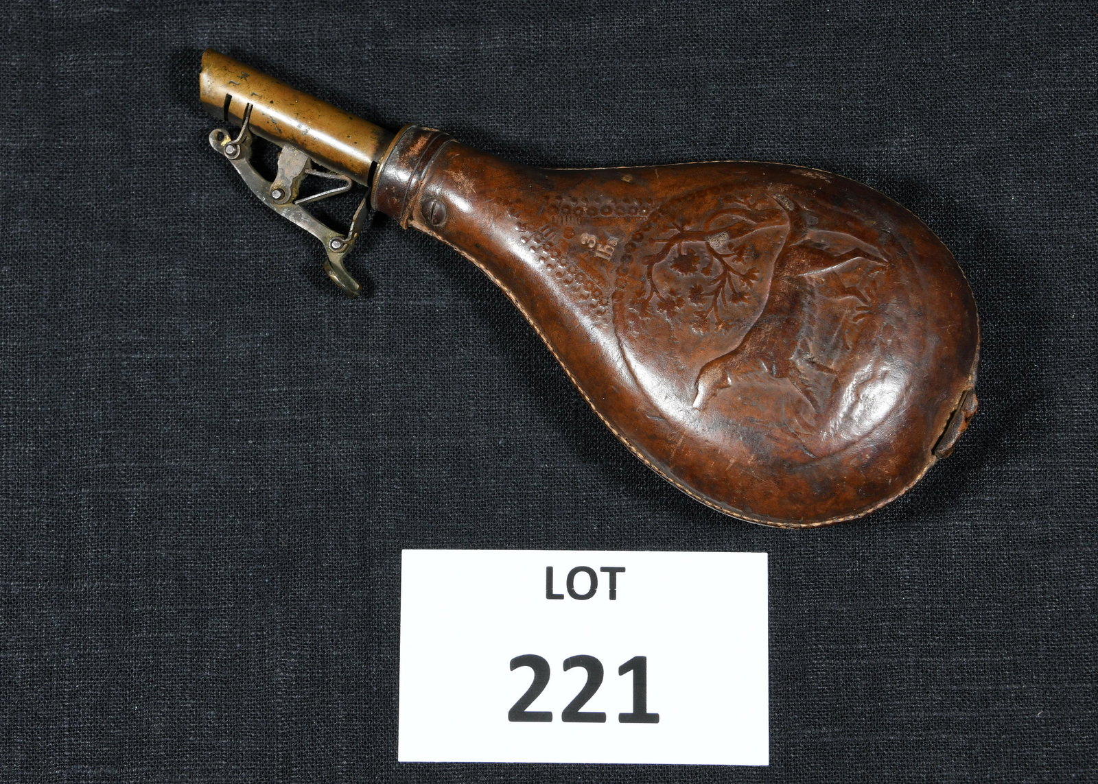Civil War Era Gun Powder Flask: A Civil War era gun powder flask with leather body and brass hardware. Front and back feature a hunting dog motif. "3lbs" marked on front. 8" long. *notes- some scuffing to leather and tarnish/discolo