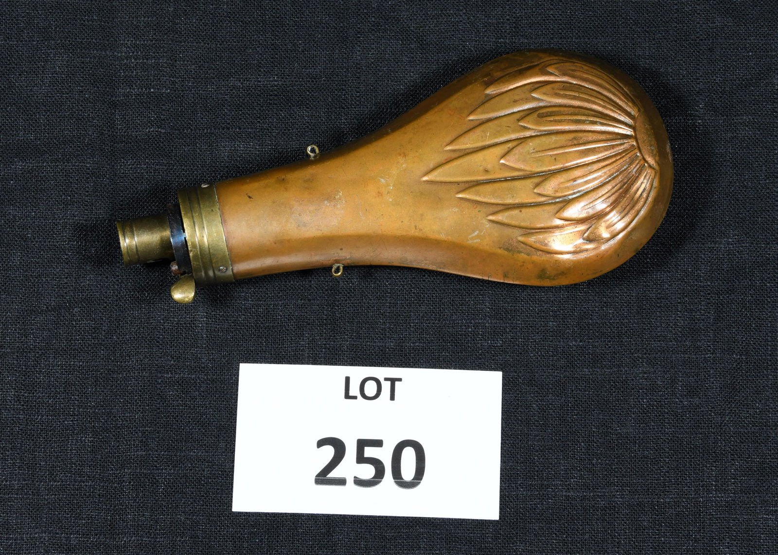 Civil War Era Powder Flask: A Civil War era copper gun powder flask with pedal design on both sides of pouch. Brass hardware. 7 1/2" long. *notes- some small dents and areas of discoloration.