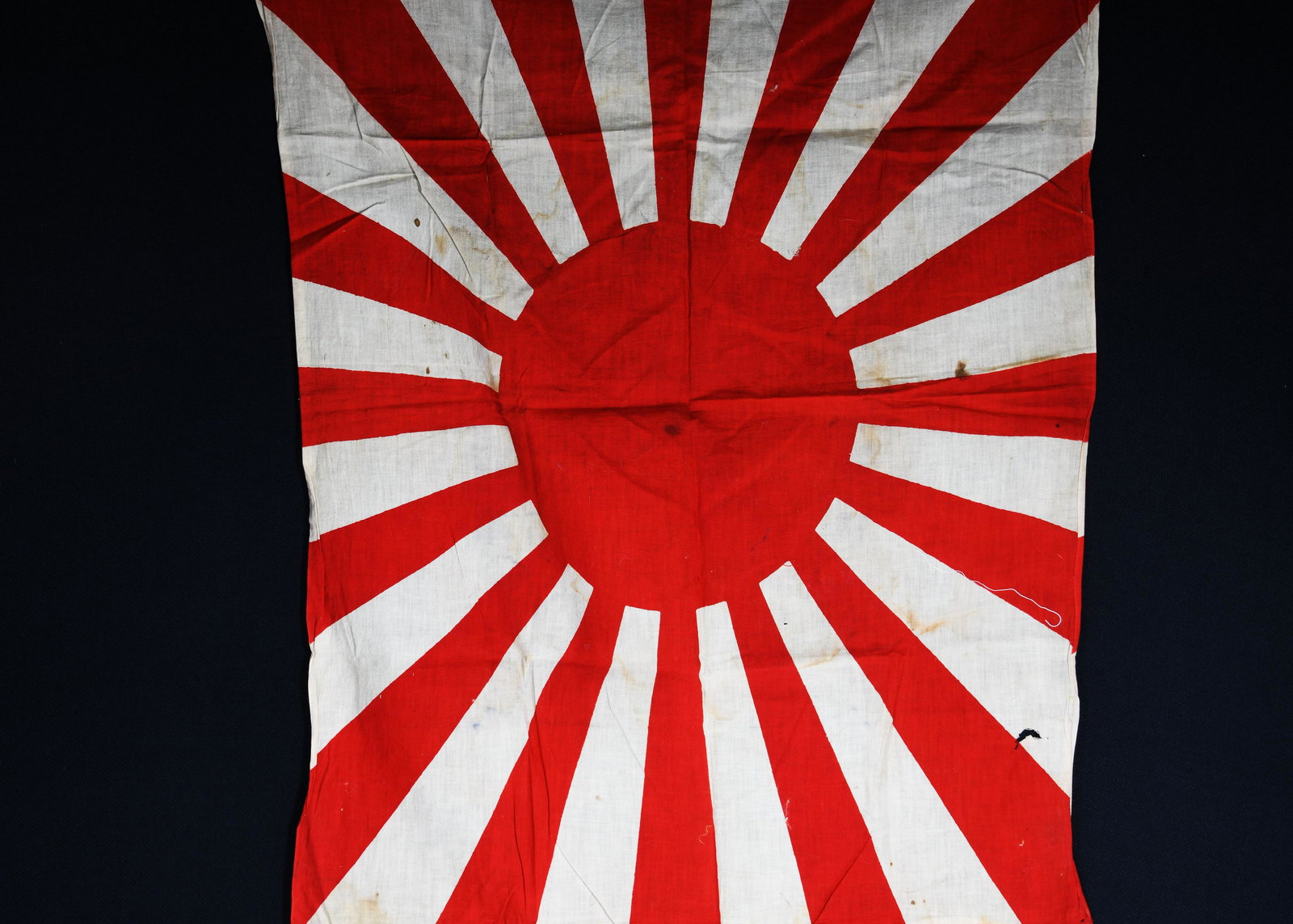 Imperial Japanese Battle Flag: An Imperial Japan rising sun battle flag. Measurements are 33"x24". *notes- significant staining, holes and wear.