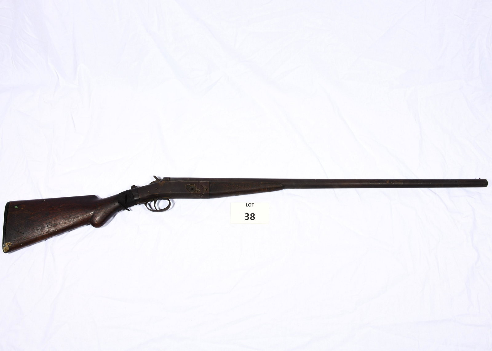 Acme 12 Gauge Single Shot Shotgun: An Acme 12 gauge single shot shotgun manufactured by W.H. Davenport Firearms Co. 30" barrel. Has cracks on the wrist and wrapped in tape. Made between 1900-1908. Total length is 49". *notes- has some
