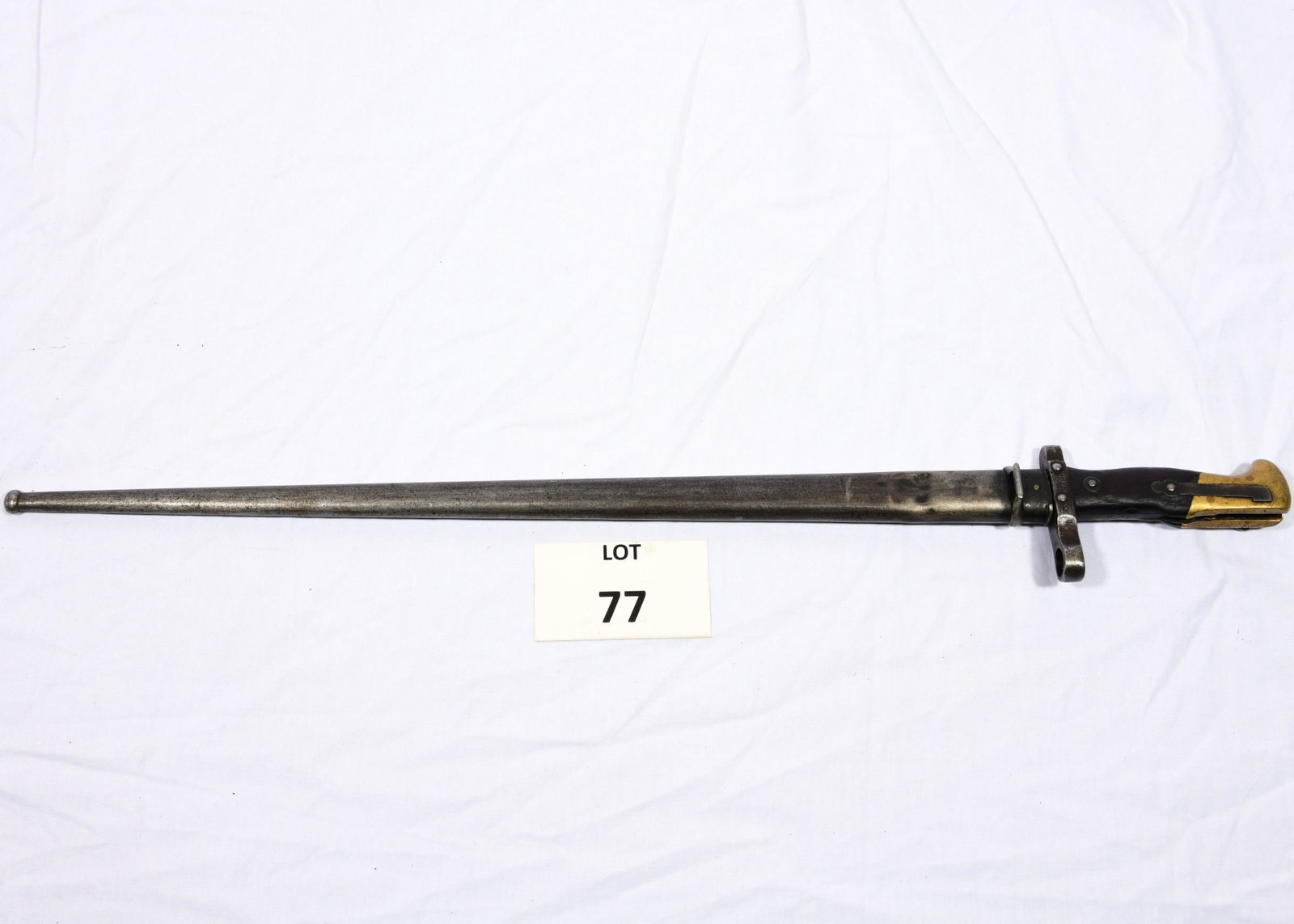 French "Mre 'D'Armes de Chat" Bayonet: An antique French made bayonet marked "Mre 'D'Armes de Chat, 1878" on the blade. Other markings include "x 19868." Grip is made of wood and brass. Includes scabbard. 25 1/4" long. *notes- scabbard is 