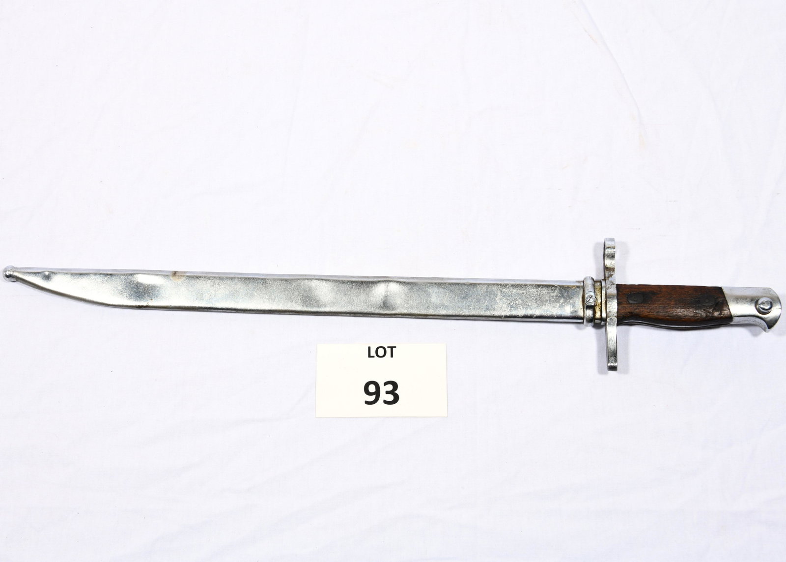 Antique Bayonet: An antique bayonet with steel blade and scabbard. Wooden grip/handle. 21" long. *notes- scratching, wear and dents.